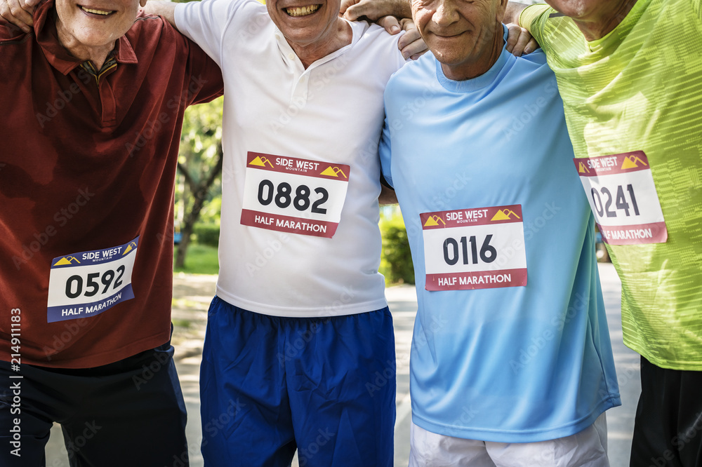 Group of cheerful senior runners at the park