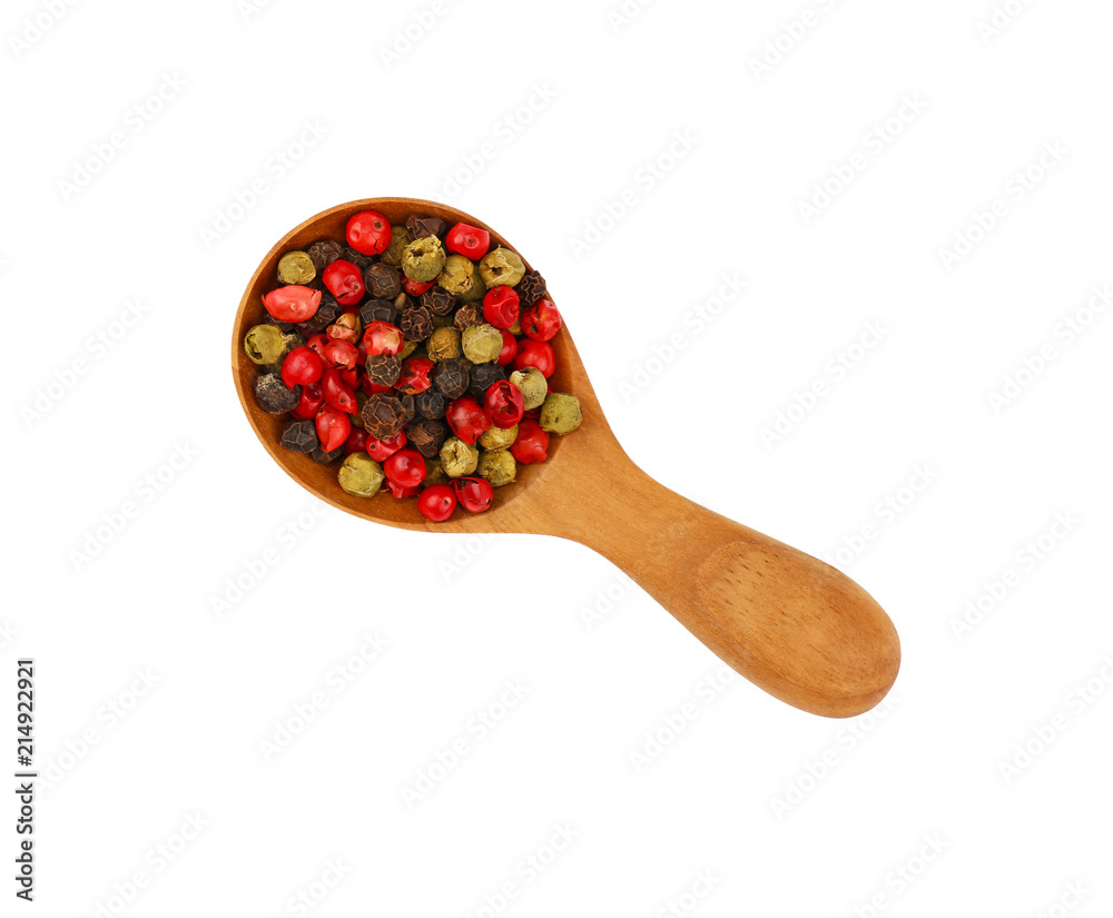 Wooden scoop spoon full of mixed peppercorns