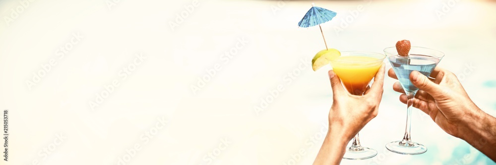 Hands of couple toasting martini glass