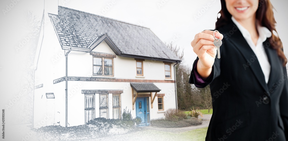 Composite image of smiling businesswoman holding a key