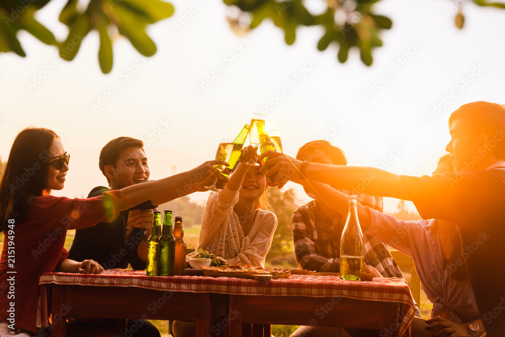 Group of 6 teenager have dinner party celebrating at sunset toasting for success