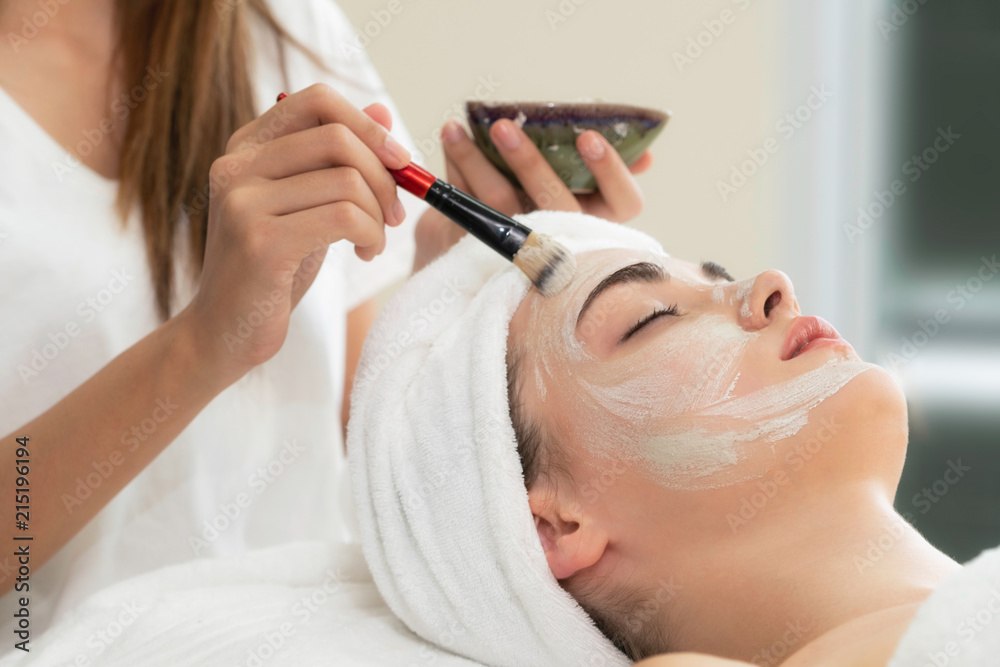 Beautiful woman having a facial treatment at spa.