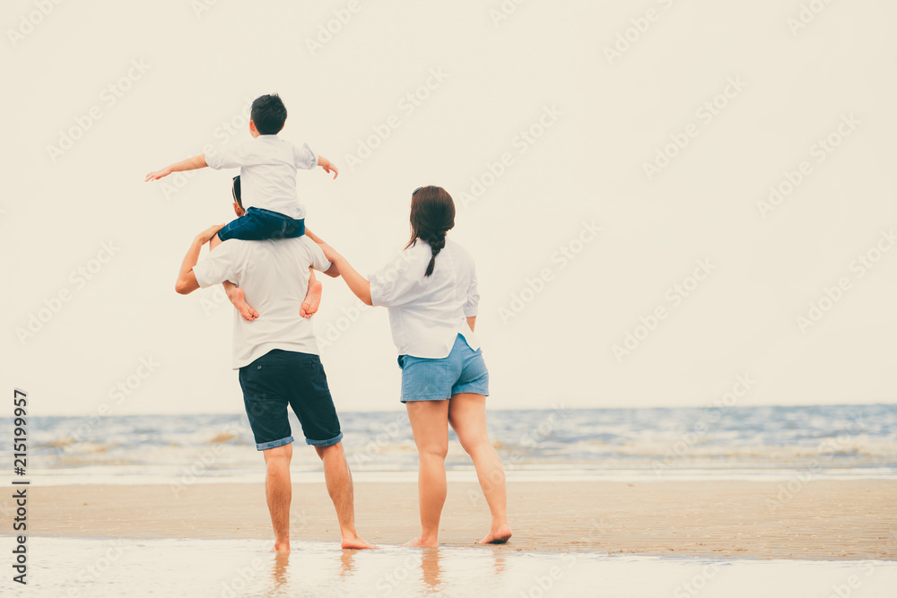 Happy family goes vacation on the beach in summer.