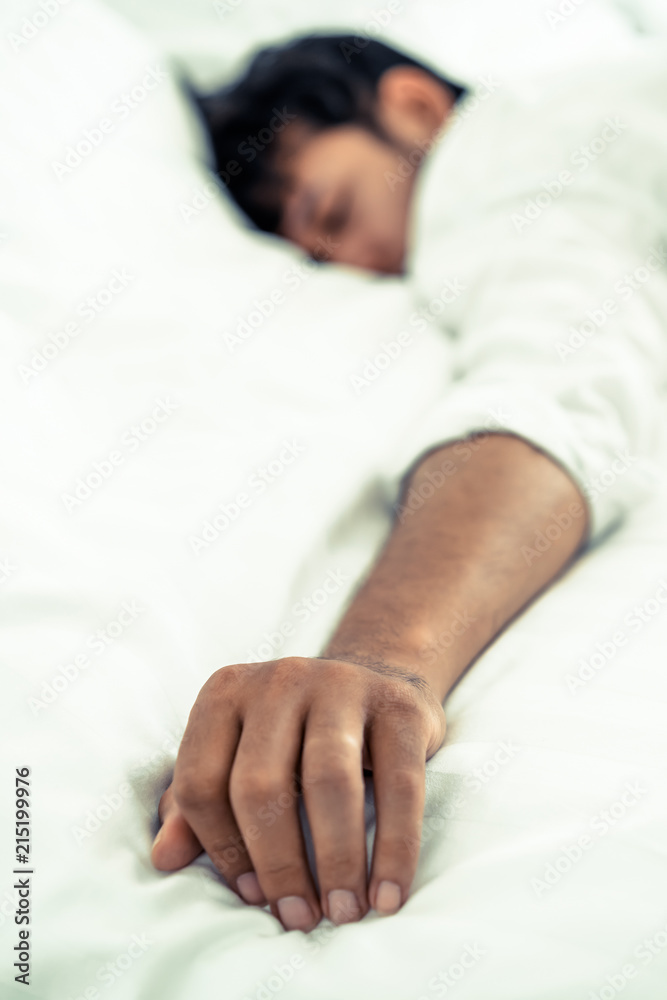 Young man sleep in bed in the bedroom.