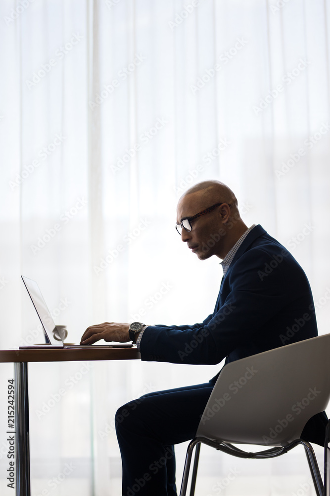 Businessman working on laptop computer in office