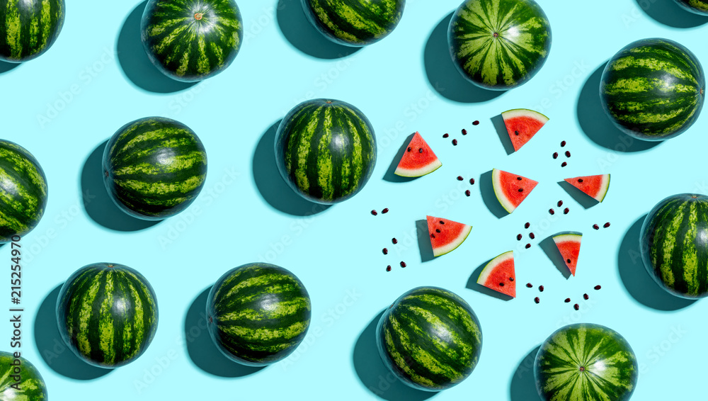 Whole and sliced watermelons on a blue background