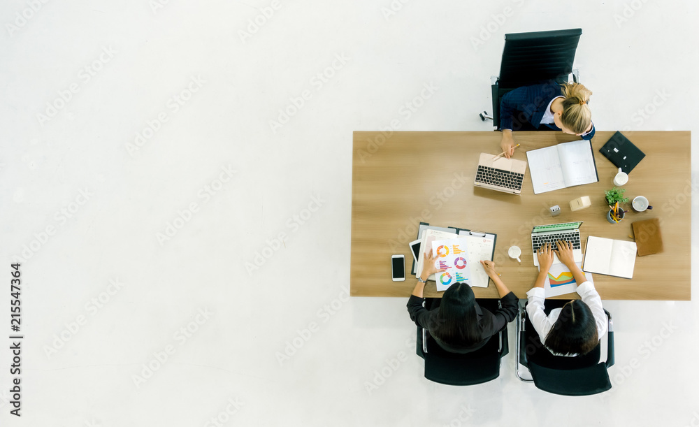 Business meeting. Top view of buinesswoman team while sitting at the office table together