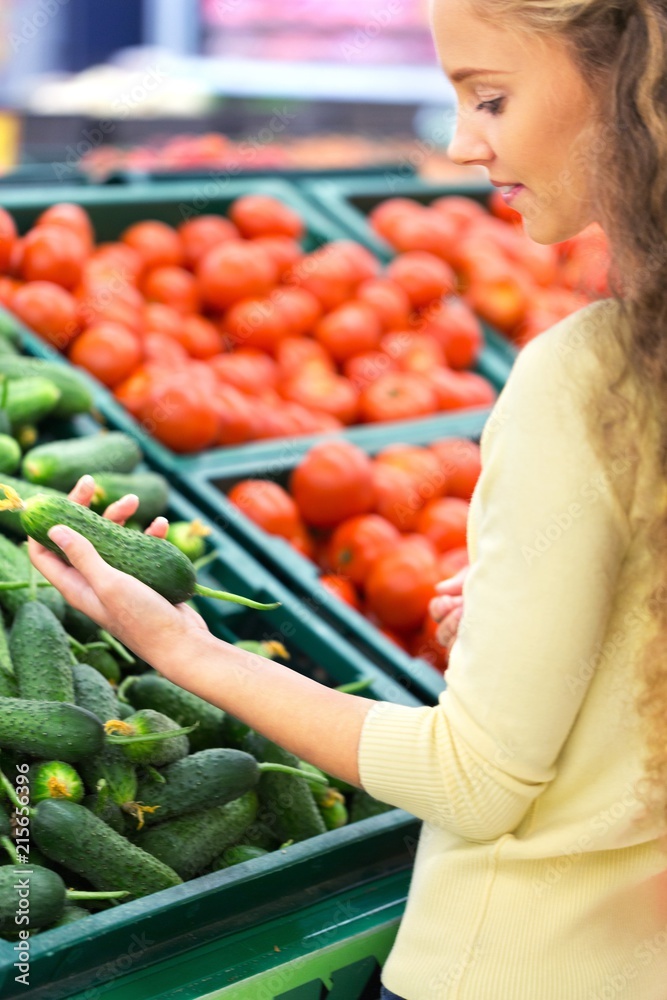 Portrait of a Woman Choosing Vegetables in a Supermarket