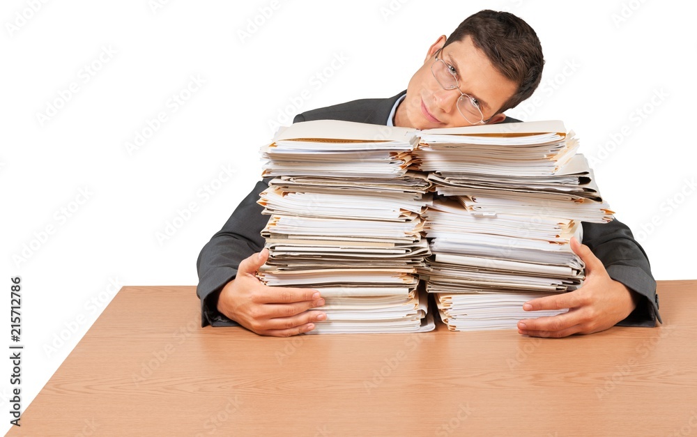 Portrait of an Unhappy Employee Behind a Stack of Documents