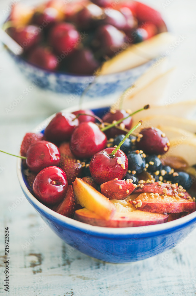 Healthy breakfast smoothie bowl with fresh fruit, berries and honey on wooden background, top view, 