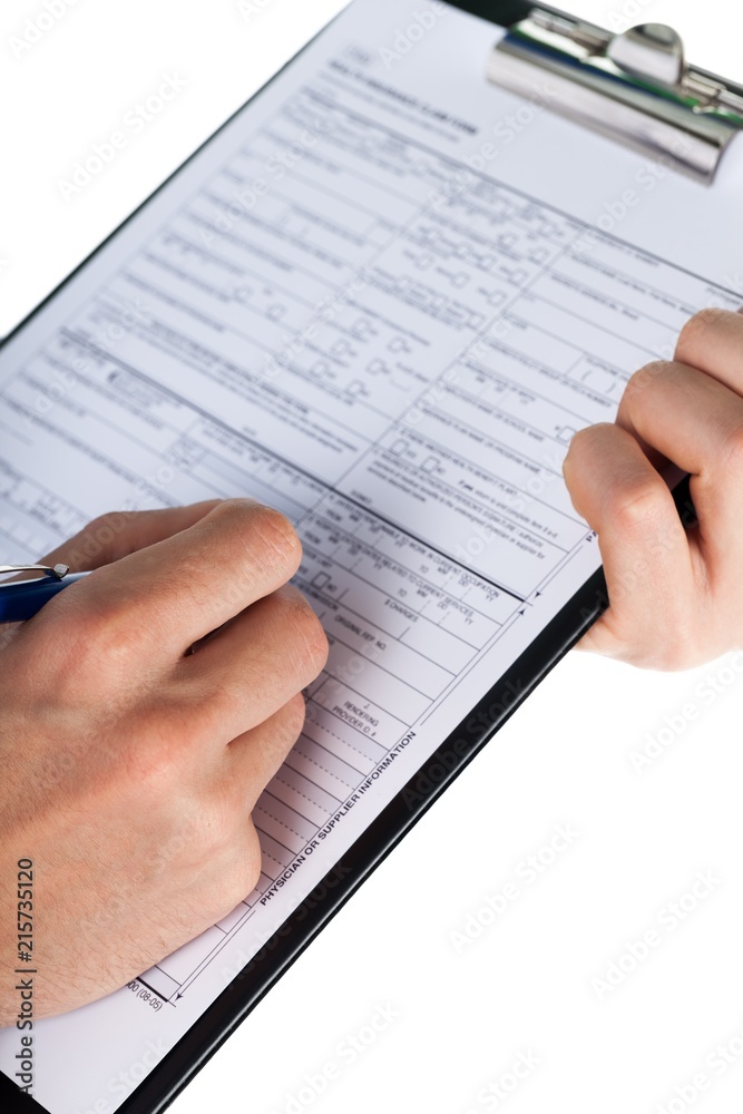 Hand Filling a Health Insurance Document with Stethoscope