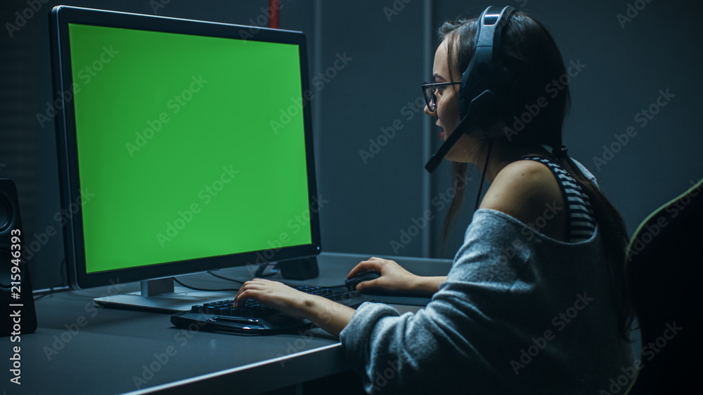 Beautiful Professional Gamer Girl Playing in Video Game on Her Personal Computer with Green Screen M