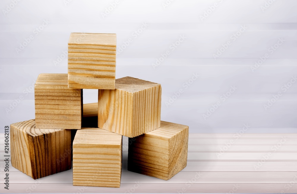 Wooden cubes on table background