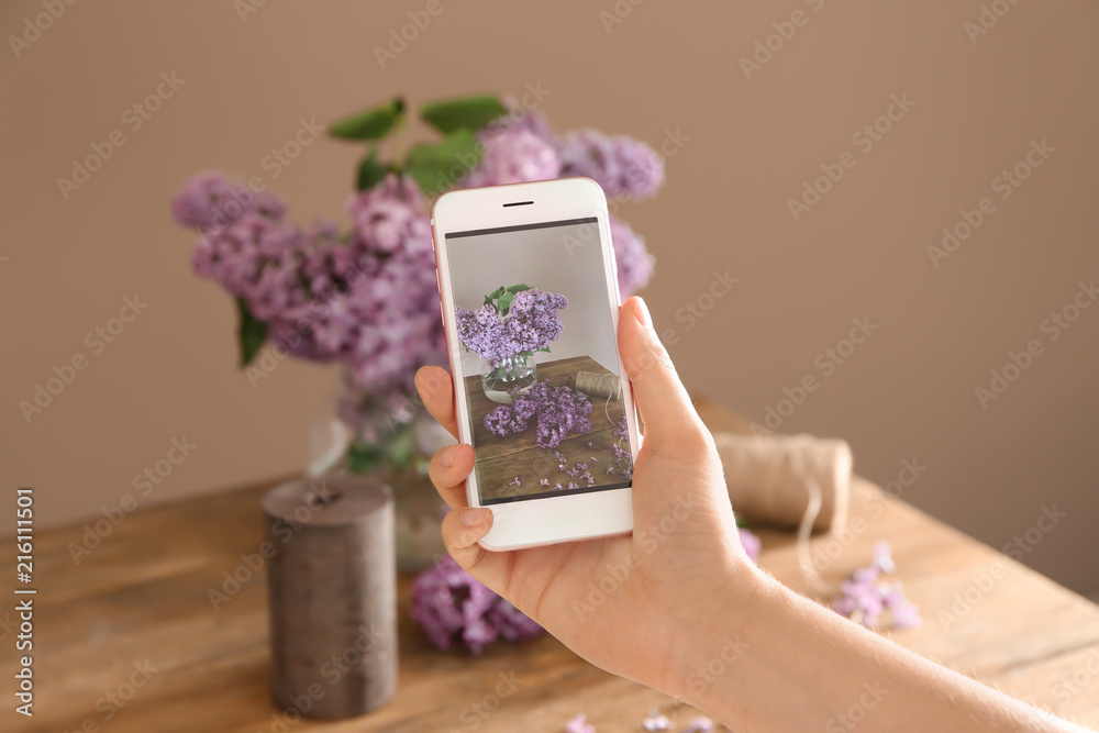 女人在拍美丽的丁香花，特写