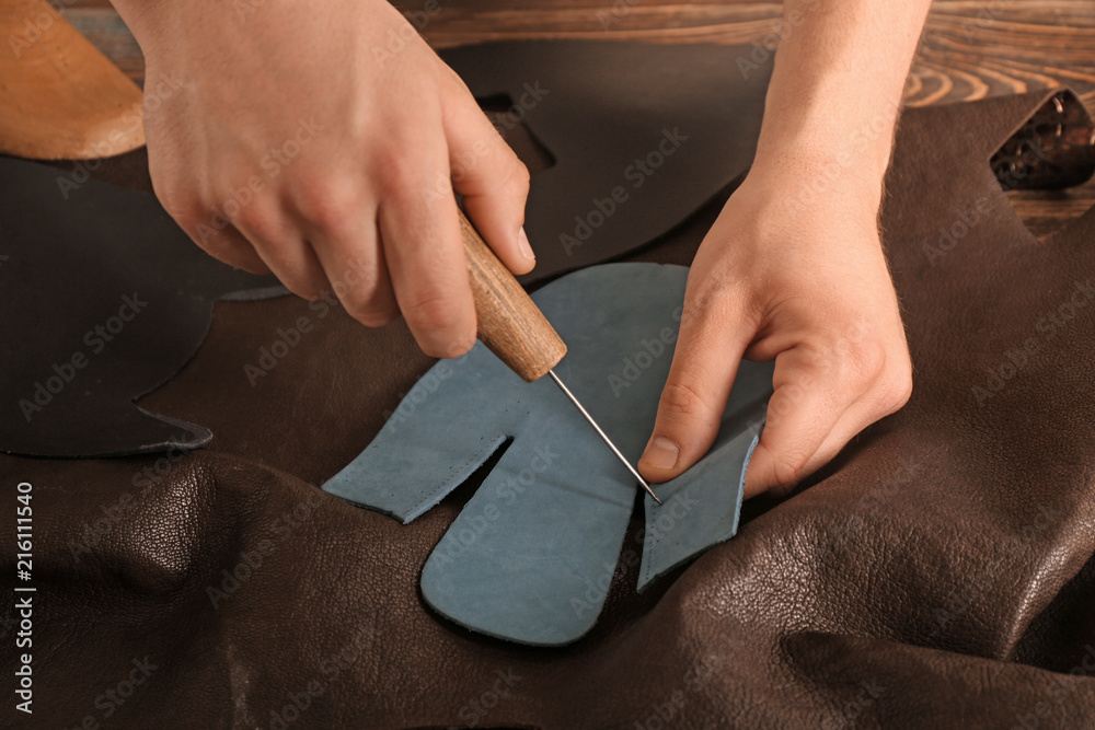 Man working with leather at factory