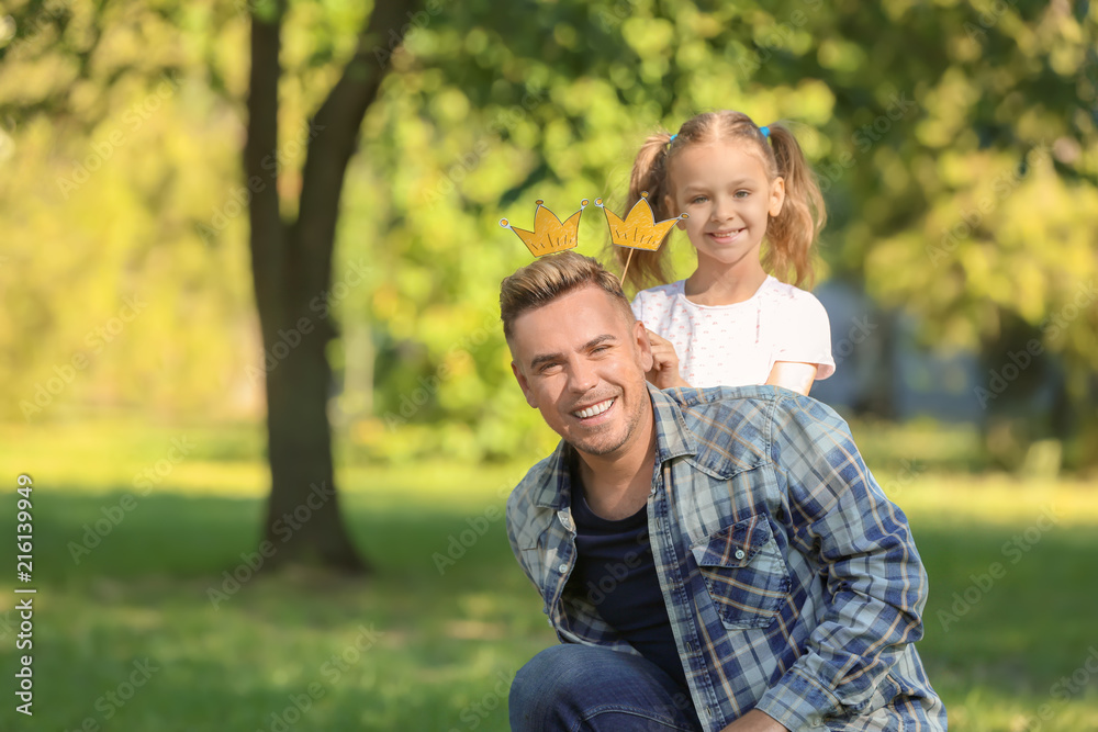 Happy father and daughter in green park