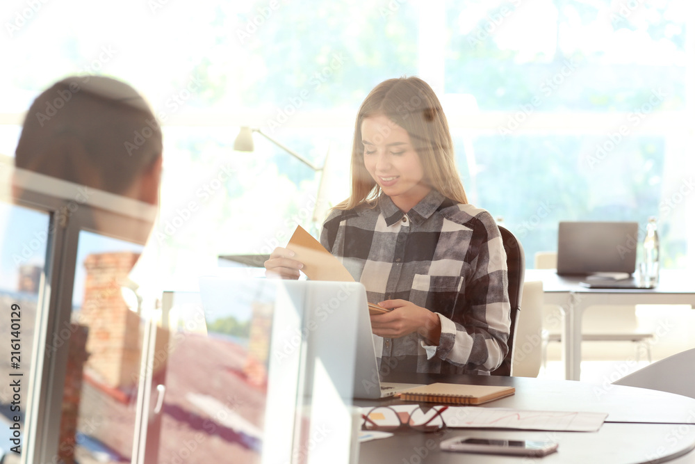 Employees having business meeting in office, view through glass