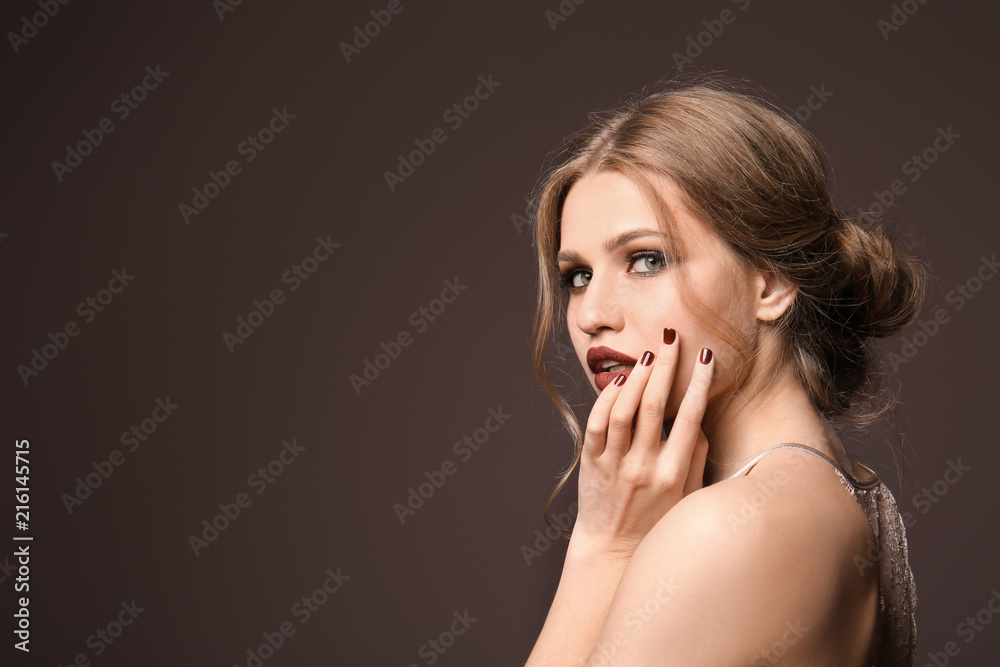 Fashionable young woman with beautiful manicure on color background