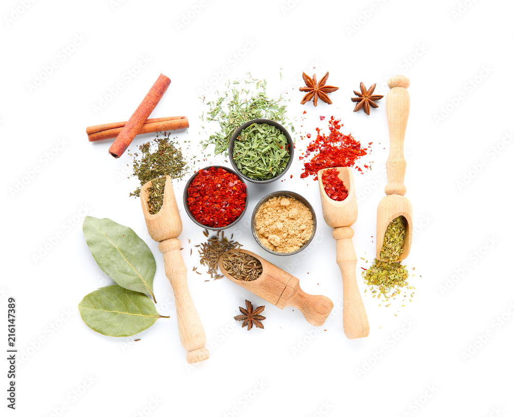 Composition with different dry spices on white background