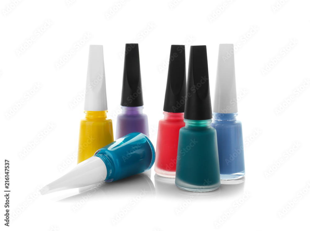 Bottles of colorful nail polishes on white background