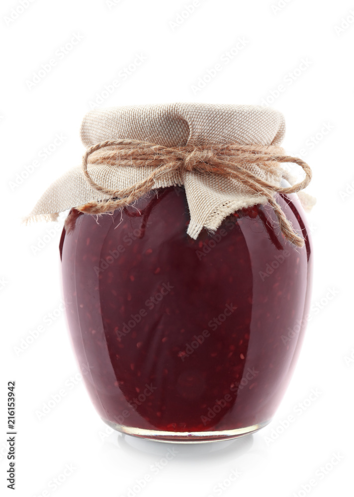 Glass jar with raspberry jam on white background