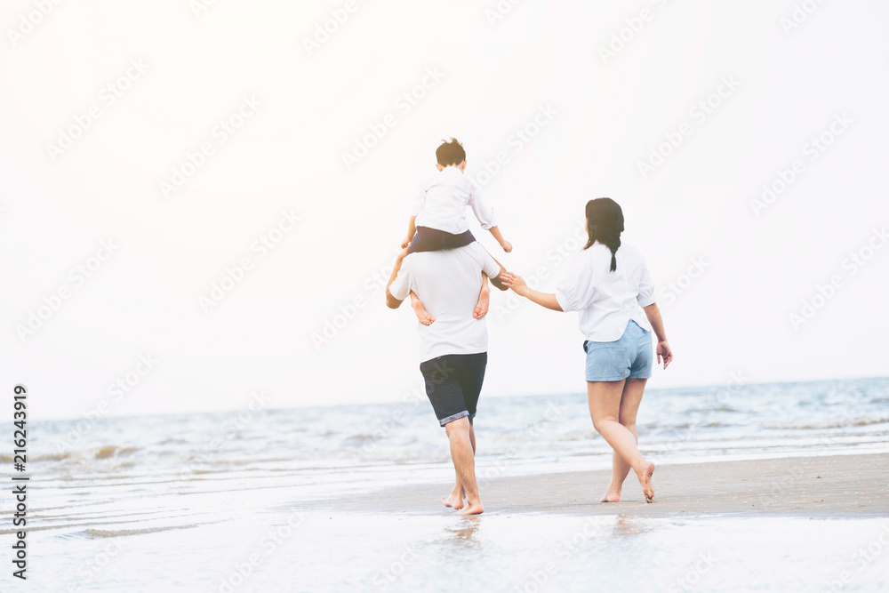 Happy family goes vacation on the beach in summer.