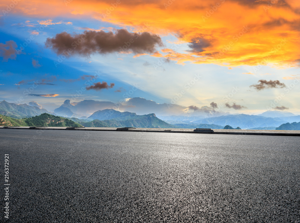 Asphalt highway and mountain natural landscape at sunrise