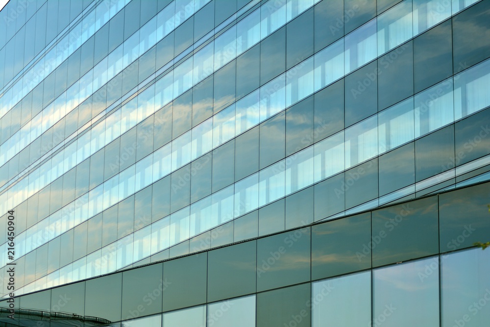 Sky and clouds reflecting on a building with mirrored glass