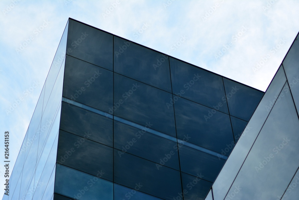 Sky and clouds reflecting on a building with mirrored glass