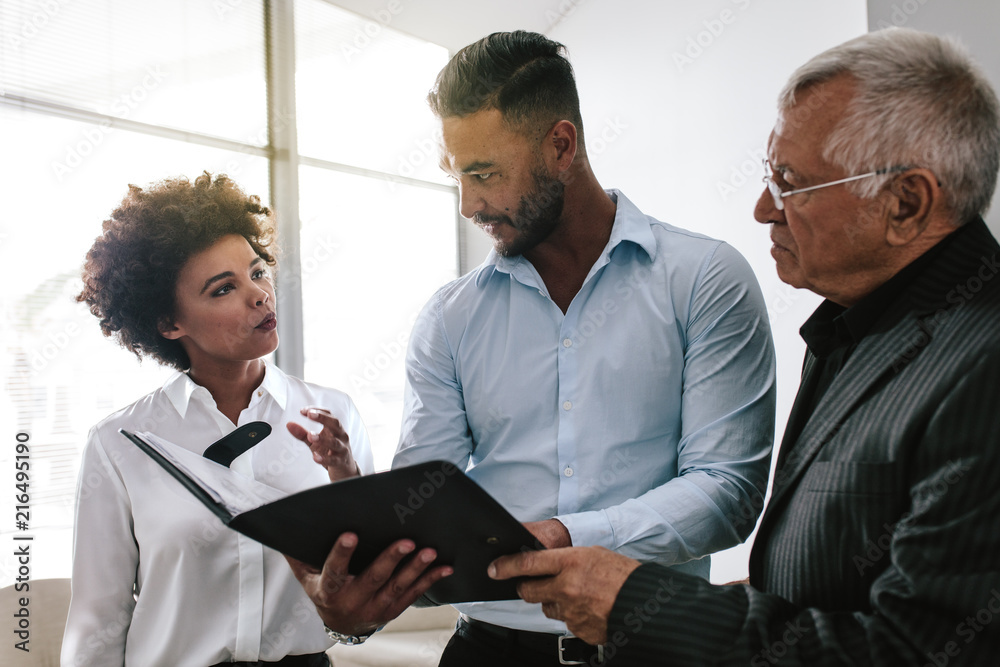 Business team discussing over a business report