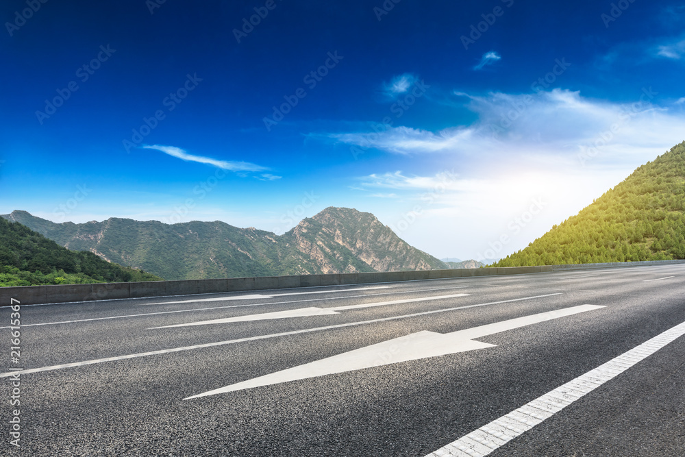 Empty asphalt road and mountains natural scenery at sunrise