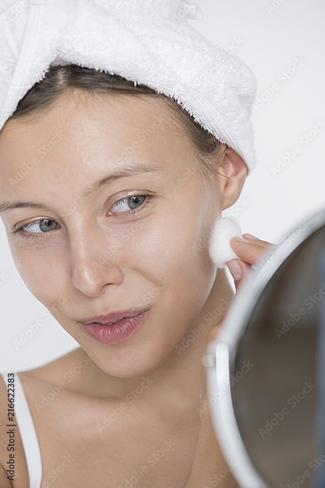 Portrait of white woman doing her daily skincare routine