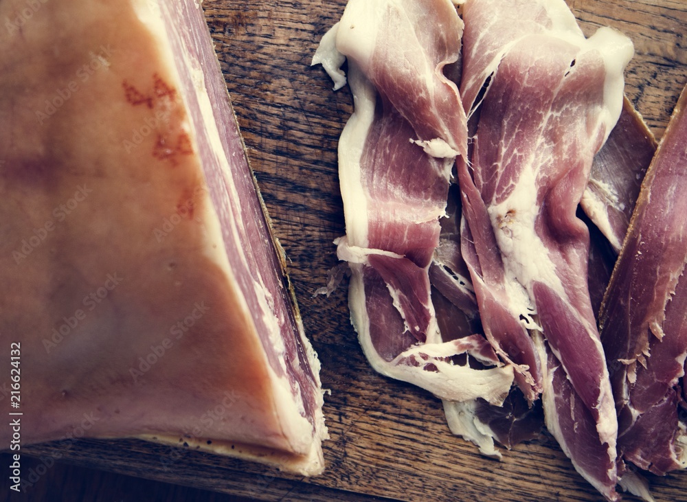 Dry-cured ham on wooden board