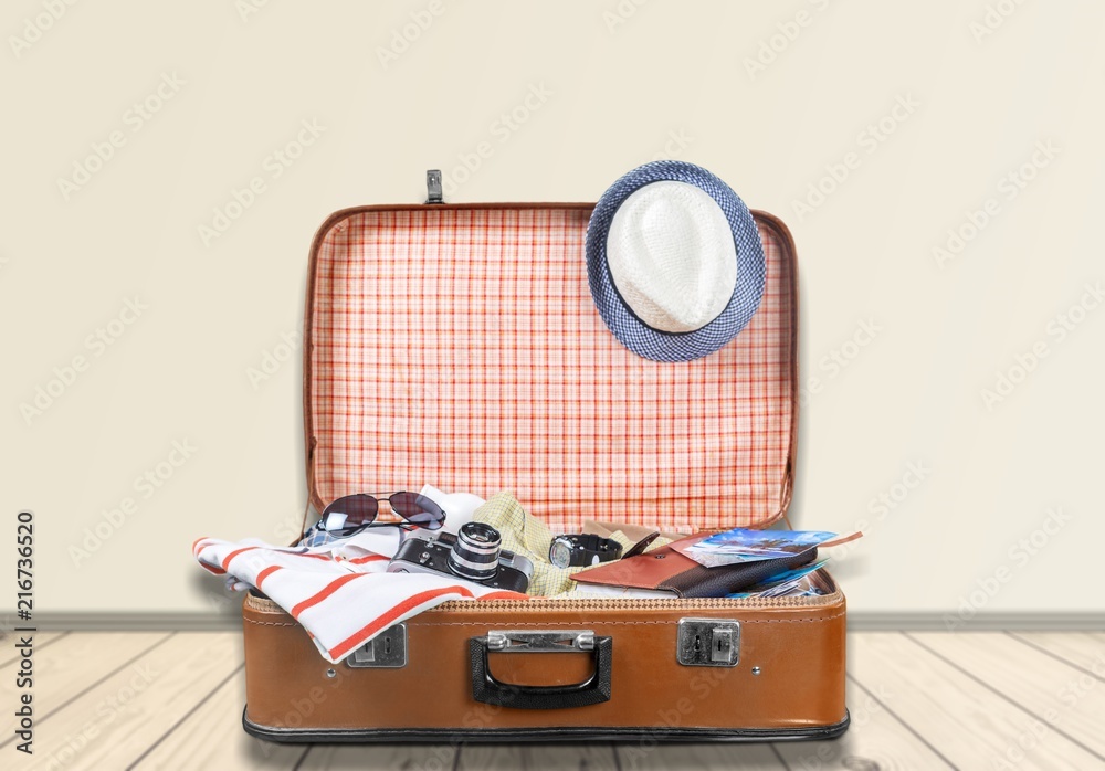 Travel bag on wooden floor and blue