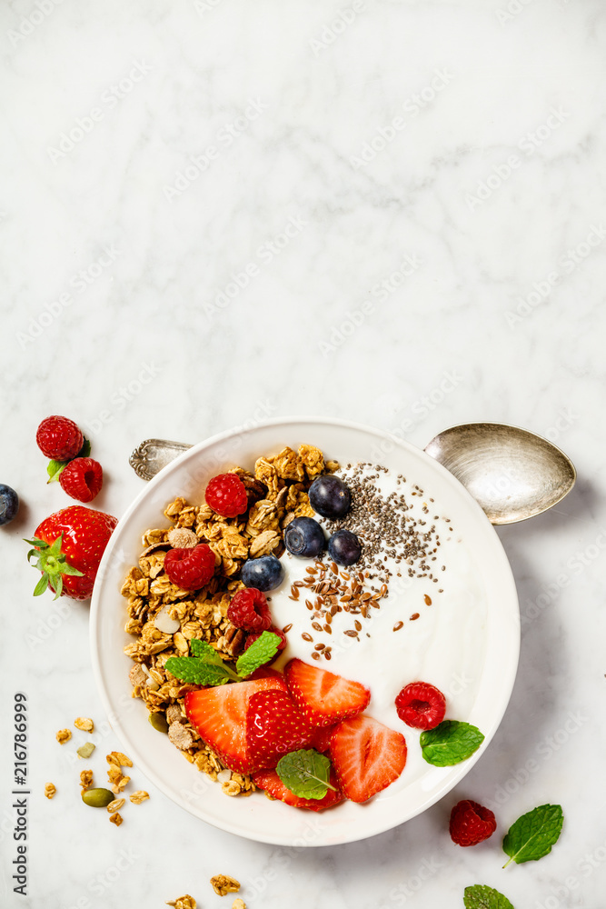 Bowl of homemade granola with yogurt and fresh berries