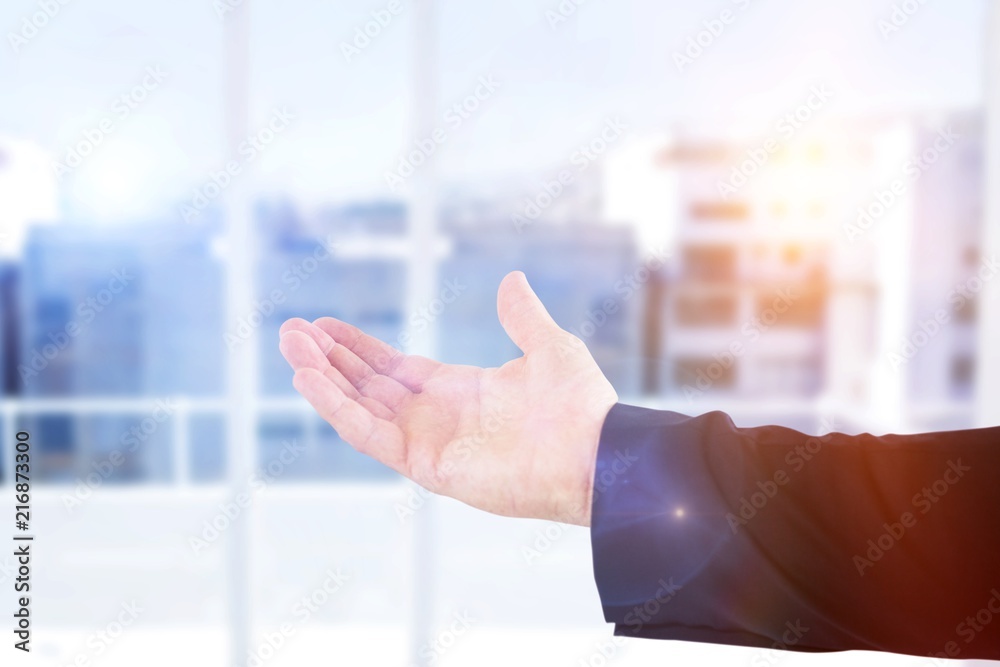 Composite image of cropped hand of male executive showing hand