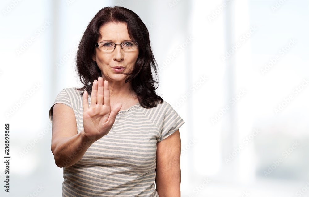 Middle-aged woman showing stop sign