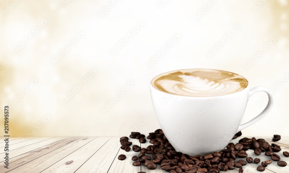 Coffee cup and coffee beans on desk