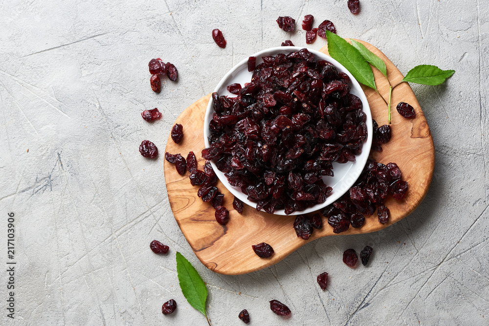 Dried cherry in a bowl over gray background. Top view.