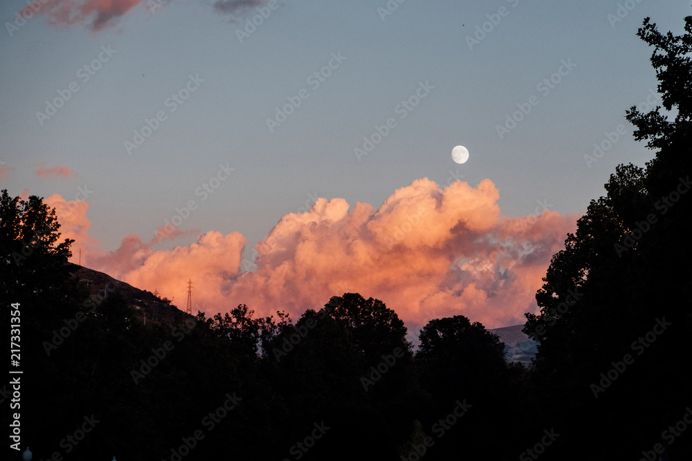 Full moon and red clouds in Granada, Spain