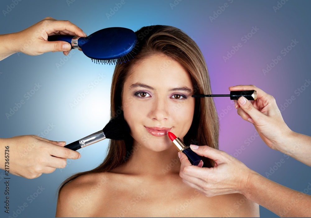 Beautiful woman with make up brushes