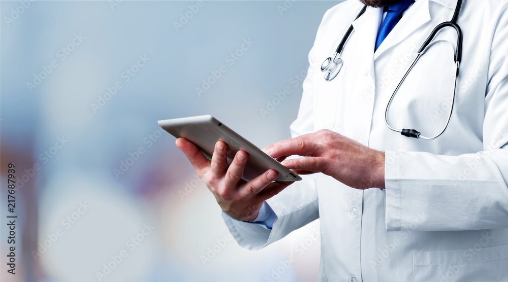 Doctor at hospital working with tablet