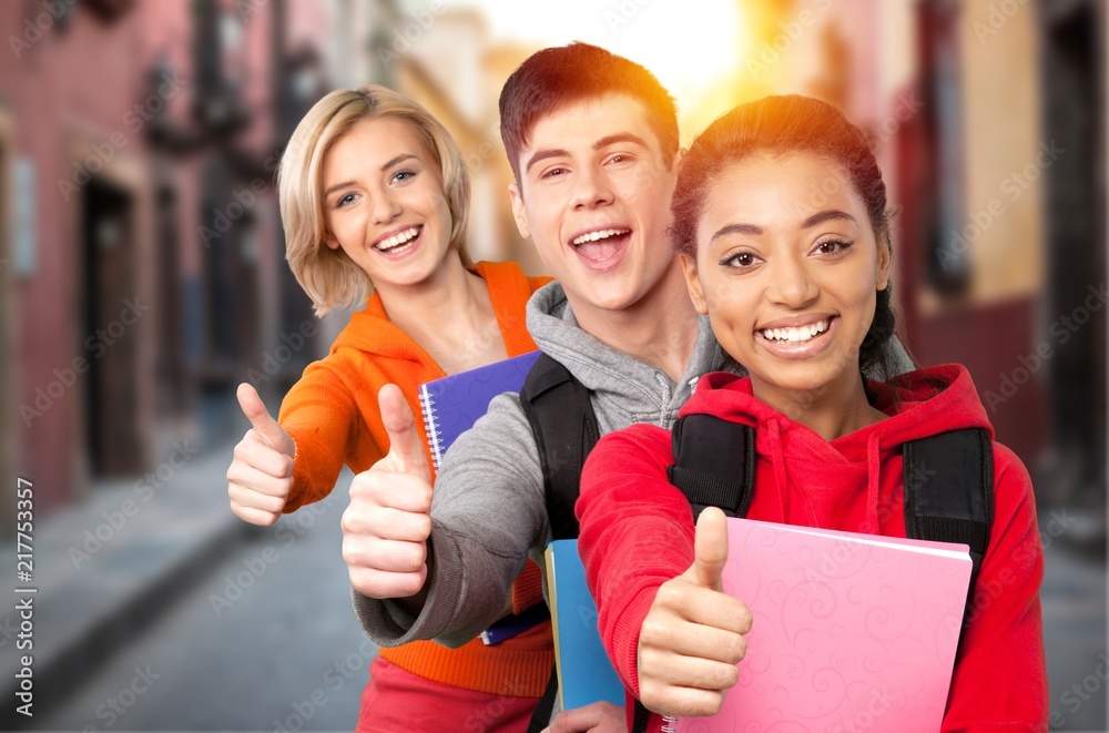 Group of smiling students showing ok