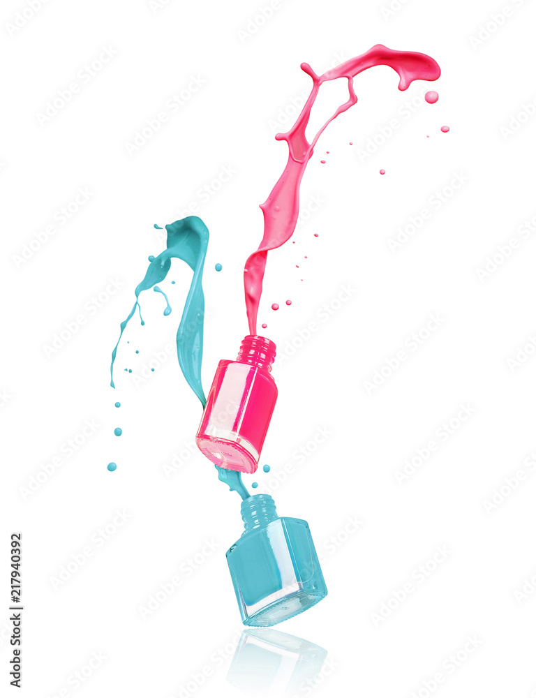 Splashes of nail polishes poured from bottles on white background