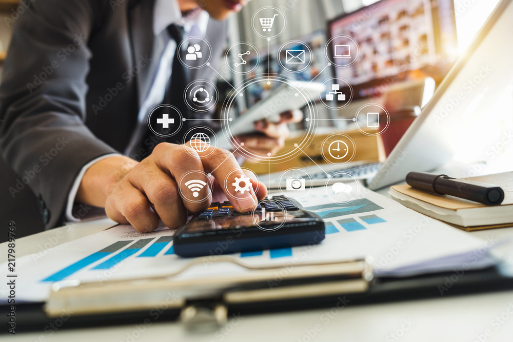 businessman hand working with finances about cost and calculator and laptop with tablet on withe des