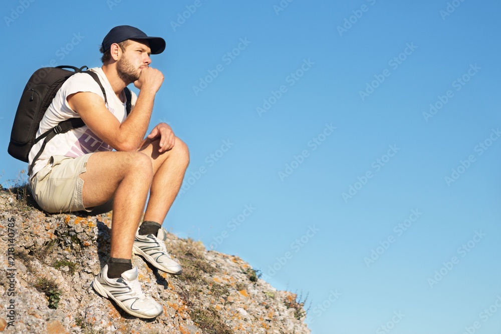 Man Sitting on Rock