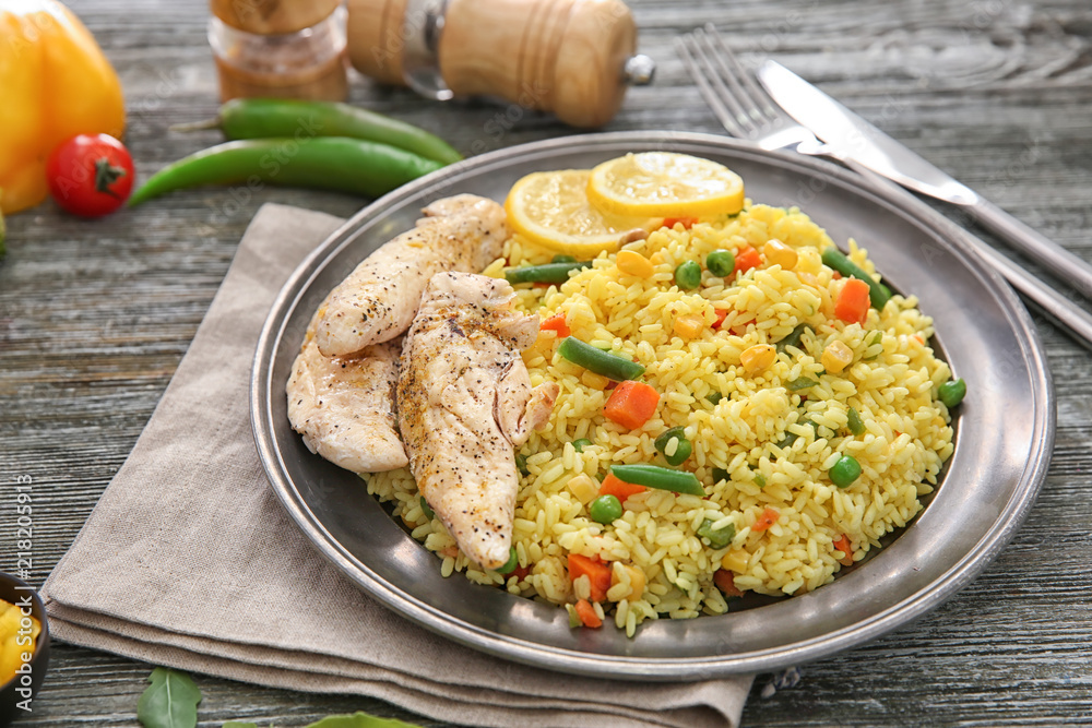 Tasty boiled rice with meat and vegetables on plate