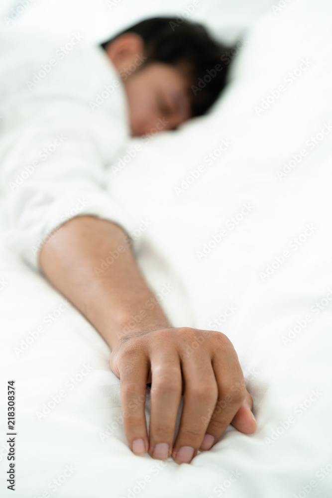 Young man sleep in bed in the bedroom.