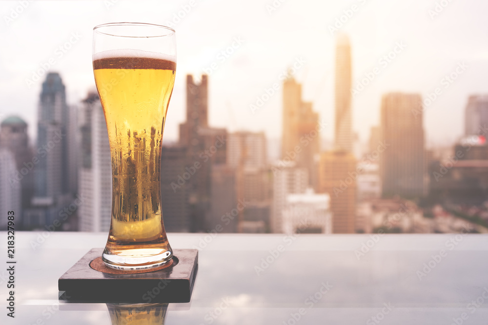 Glass of beer on table in rooftop bar in Bangkok