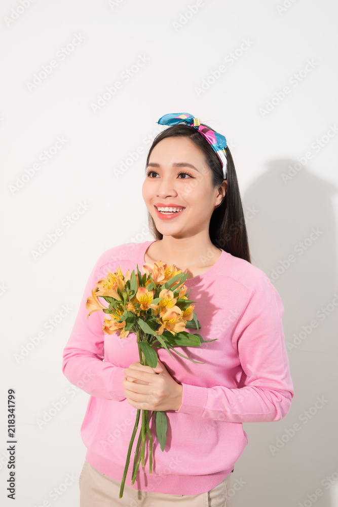 Toothy smiling happy woman holding flower . White background isolated portrait.